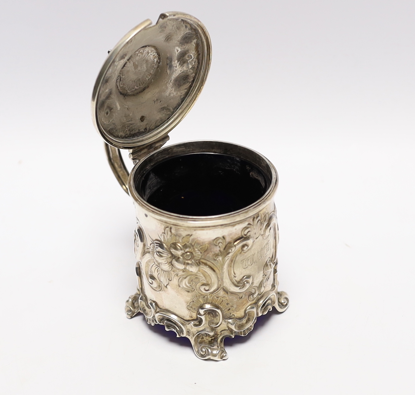A Victorian embossed silver drum mustard, John Evans II, London, 1863, decorated with foliage and scrolls.